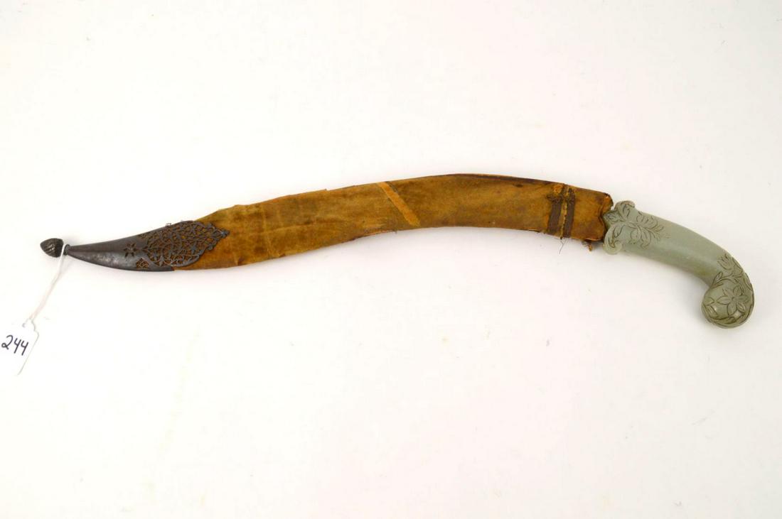EARLY OTTOMAN GOLD-DAMASCENTED SWORD. The Blade Turkish: EARLY OTTOMAN GOLD-DAMASCENTED SWORD. The Blade Turkish 18th Century, The Hilt Chinese Jade Carved floral and scroll decoration. Condition: no damage identified. Length 20 1/4" Hilt Length 5 1/4".