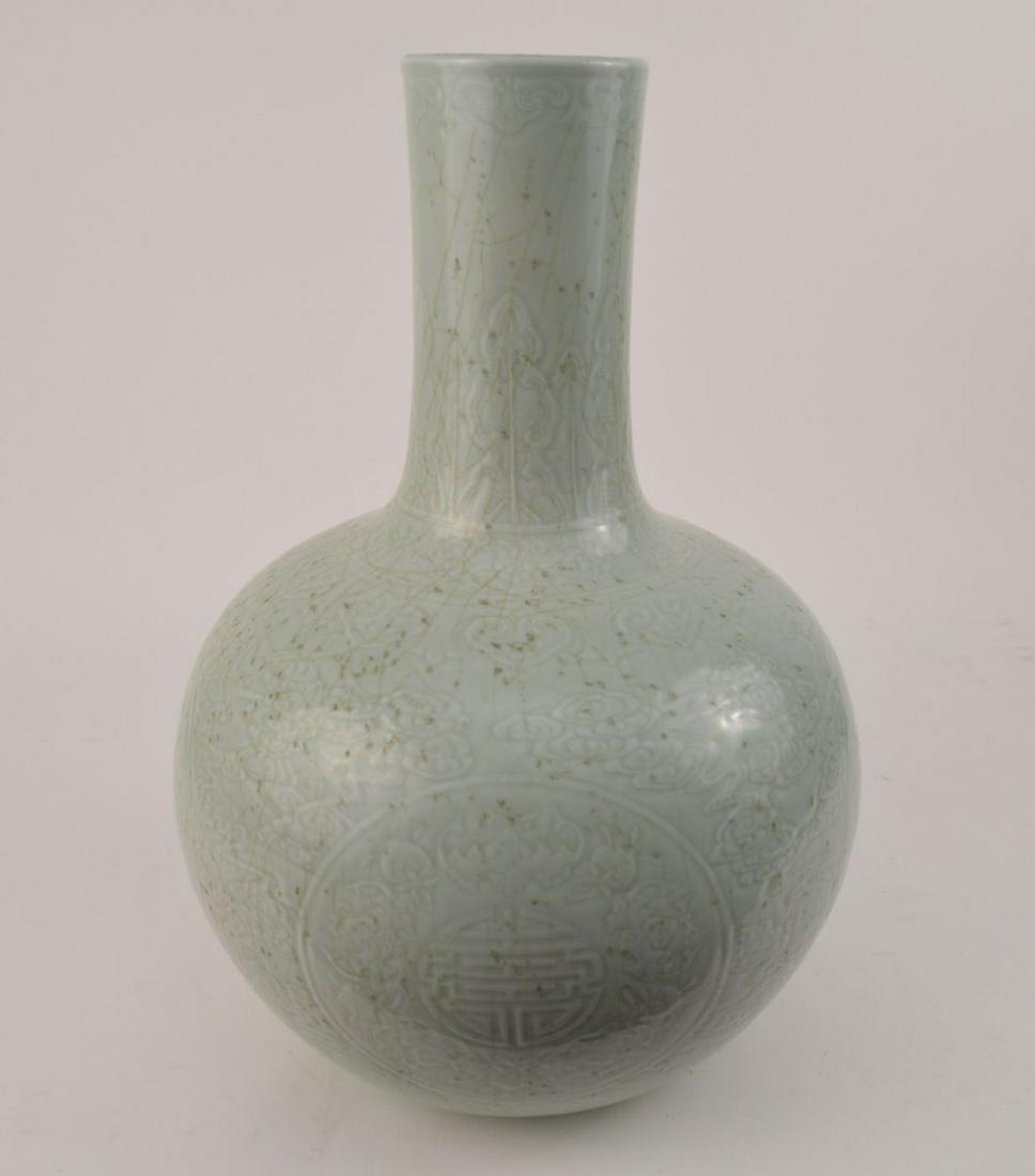 CHINESE CELADON PORCELAIN BOTTLE NECK VASE with relief: CHINESE CELADON PORCELAIN BOTTLE NECK VASE with relief decoration. The vase with Qianlong mark. Condition: no damage identified. Ht. 19 3/4" Diameter 12 5/8"