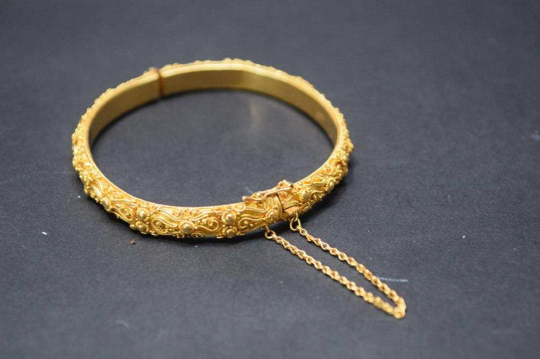 22k Yellow gold Bangle Bracelet. Condition good has: 22k Yellow gold Bangle Bracelet. Condition good has small interior dent. Weight 9.3 dwt. Size inner circumference 7" with 2" opening and safety Chain.