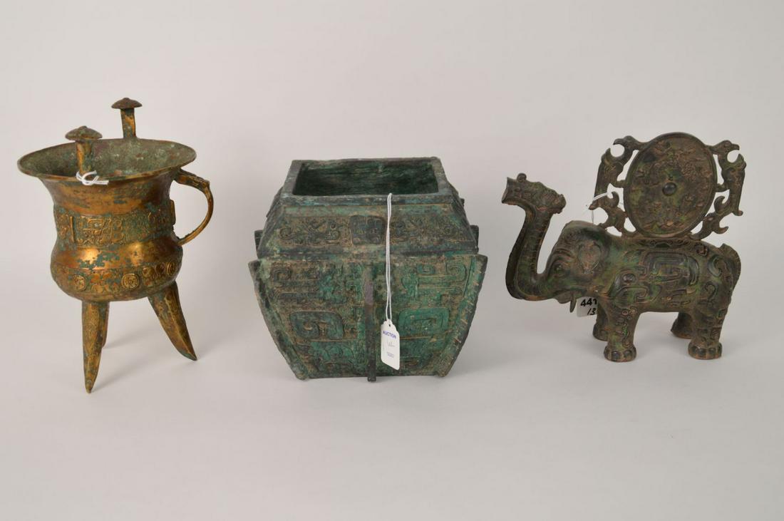 THREE CHINESE SHANG ZHOU STYLE BRONZE VESSELS -: THREE CHINESE SHANG ZHOU STYLE BRONZE VESSELS - Includes: (1) a Elephant Figural Zun Sculpture with intricate decoration, topped with an ornate medallion featuring mythological animals, green patina, 
