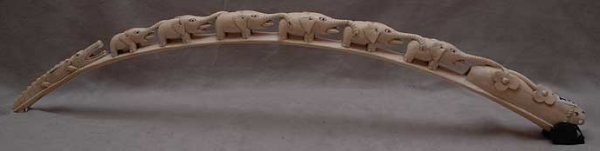 Ivory tusk with 6 elephants on the run and crocodi: Ivory tusk with 6 elephants on the run and crocodile fast approaching from the rear, 27"L