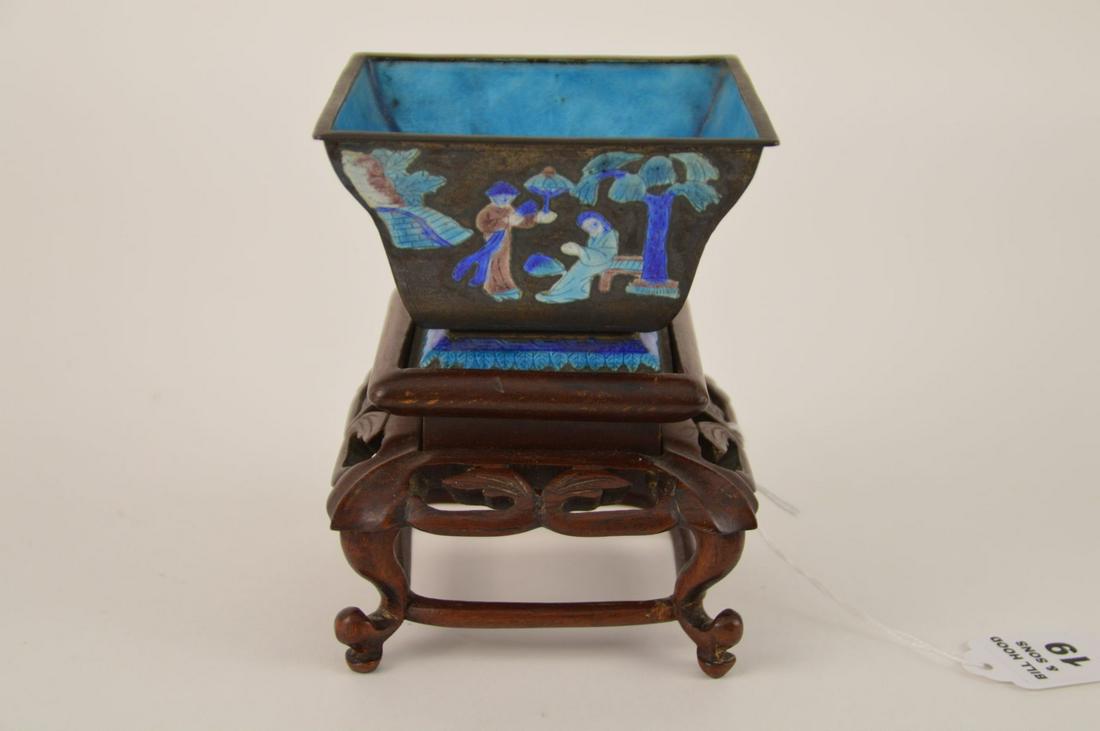 CHINESE CLOISONNE ENAMELED METAL BOWL. Condition: no: CHINESE CLOISONNE ENAMELED METAL BOWL. Condition: no damage identified. Ht. 2 3/4" W. 4 1/8" D. 4 1/8" on carved wood base. Ht. 3 3/4" W. 3 1/2" D. 3 1/2"