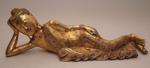 Reclining gold wood Thai figure with colored stone: Reclining gold wood Thai figure with colored stones in dress, 34"L x 11"h