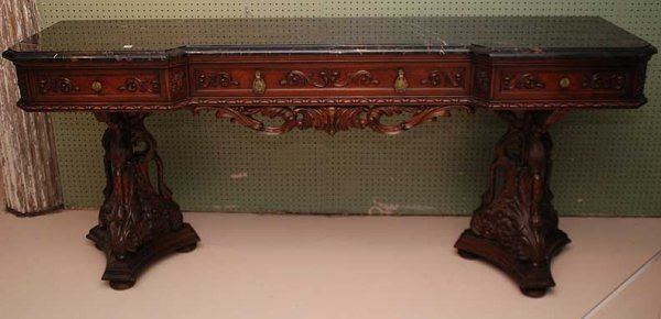 Buffet heavily carved swan heads in a trifed pedes: Buffet heavily carved swan heads in a trifed pedestal support form with carved drape frieze, 2 cutlery drawers and center long drawer with black veined marble top 7' x 37"h x 19"d