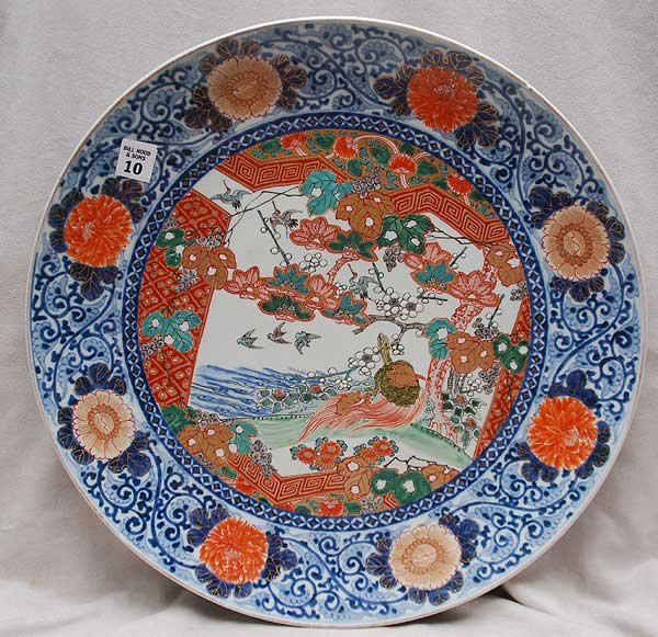 Oriental charger, blue, orange, green on white grou: Oriental charger, blue, orange, green on white ground, a minor nick to edge, 18"dia