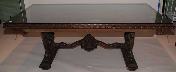 Fabulous mahogany dining table with sliding extensi: Fabulous mahogany dining table with sliding extensions at ends on trestle style base with elaborately carved floral supports, circa 1920