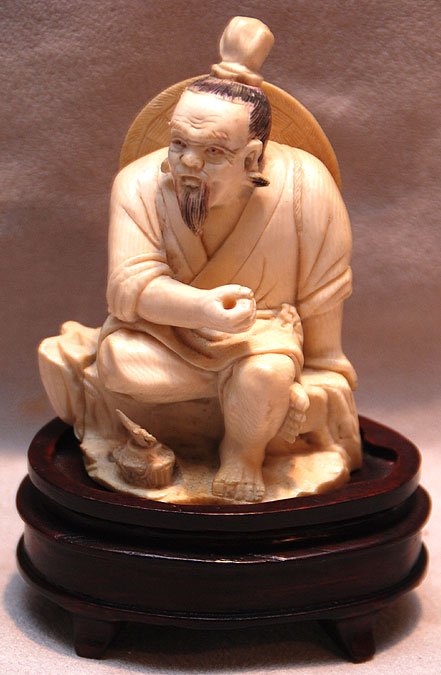 Ivory seated farmer on unattached wood stand, 4"h: Ivory seated farmer on unattached wood stand, 4"h