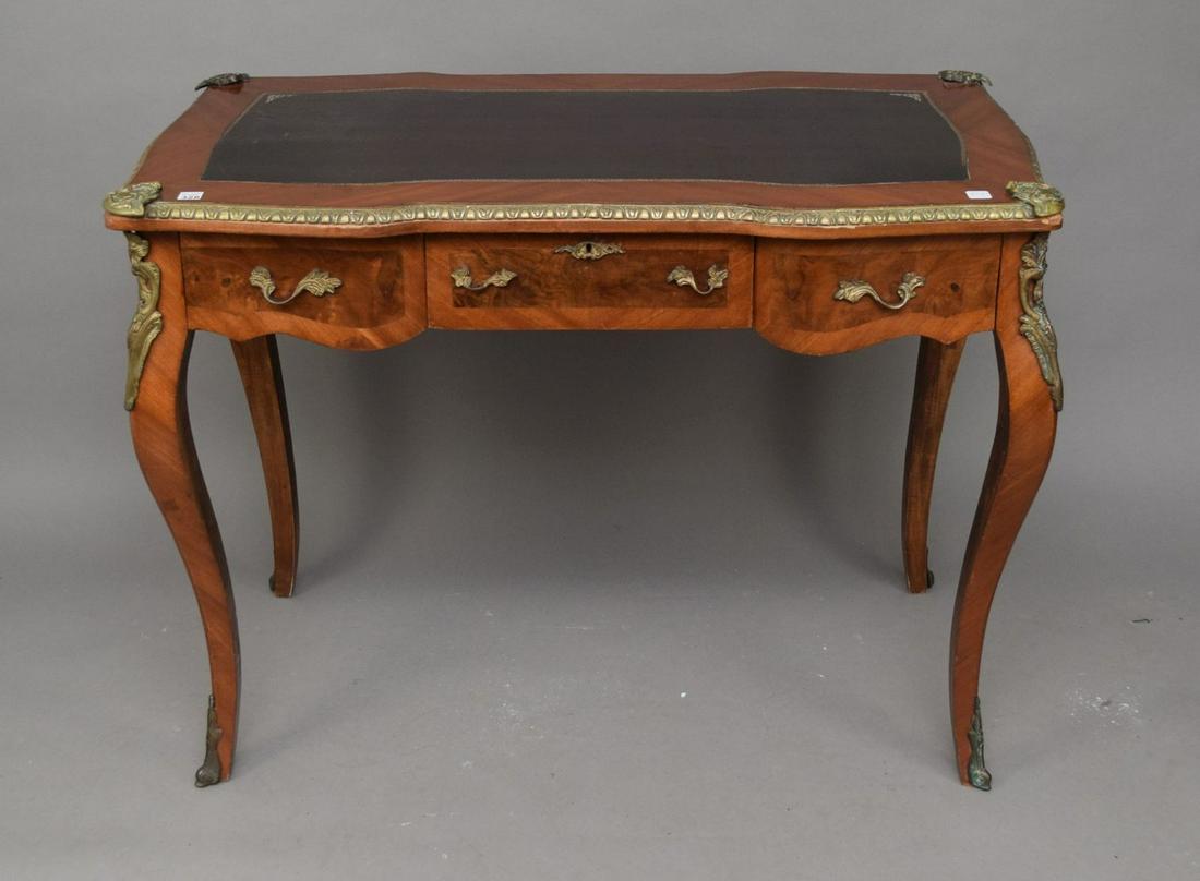 A Louis XV Style Bureau Plat, 20th Century, With black: A Louis XV Style Bureau Plat, 20th Century, With black leather top, brass pulls and escutcheons. H. 32 x W. 42 inches