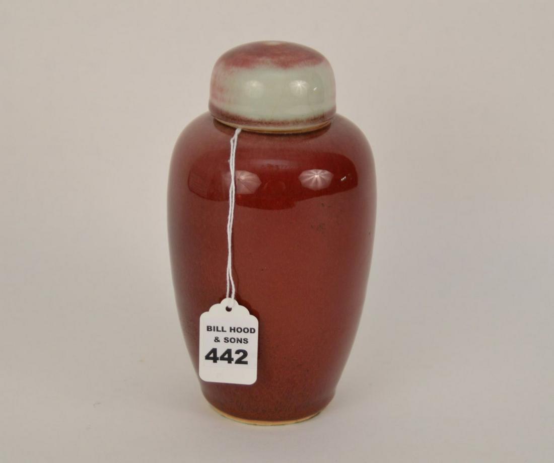 CHINESE SANG DE BOEUF PORCELAIN COVERED JAR - A covered: CHINESE SANG DE BOEUF PORCELAIN COVERED JAR - A covered jar/urn in thick lustrous Sang de Boeuf glaze the reaches almost to the bottom of vessel, leaving the rim of the foot unglazed. 7 1/2" H. Condit