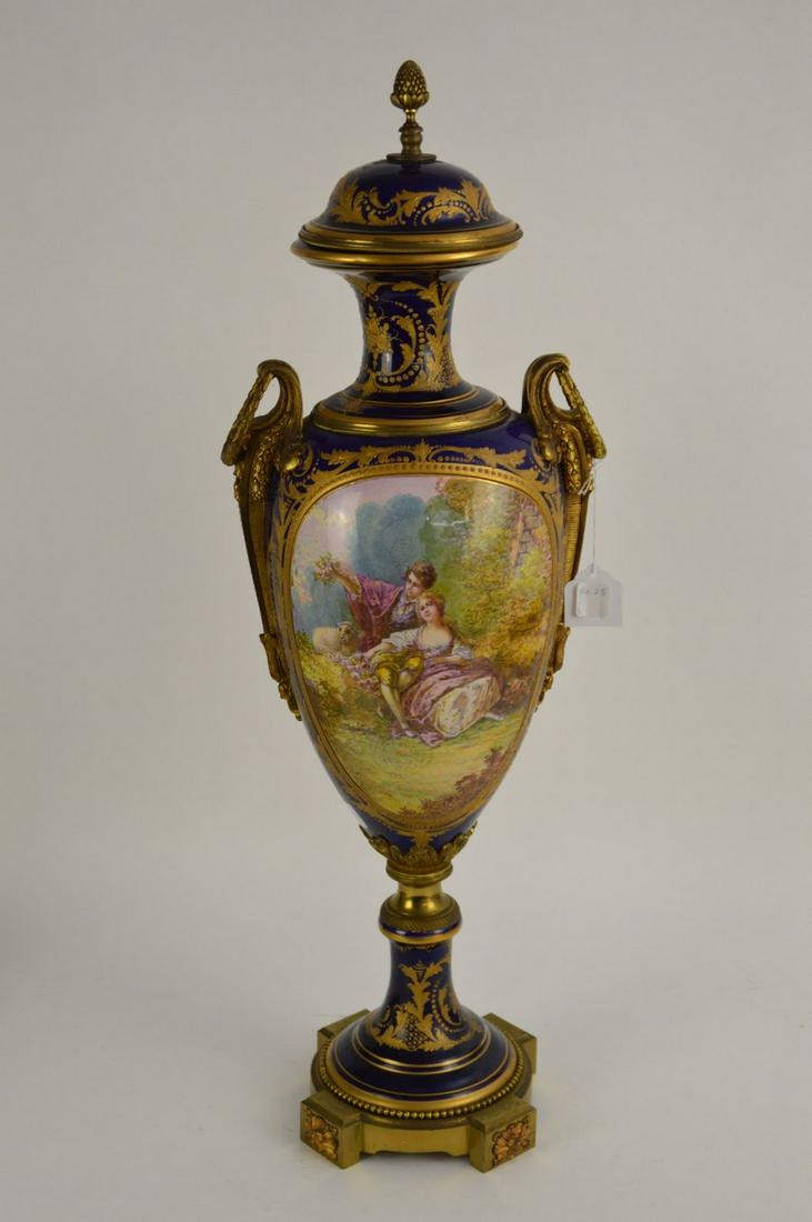 SEVRES Cobalt & Gilt Porcelain Pictorial Urn -: SEVRES Cobalt & Gilt Porcelain Pictorial Urn - Porcelain urn with hand-painted romantic couple scene on one face and landscape scene on the opposite. With gilt bronze handles, mid-column, finial, and 