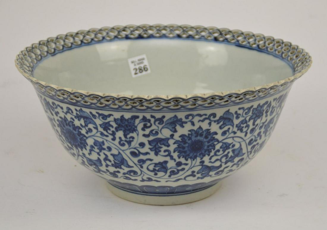 Large Chinese Blue & White Porcelain Bowl with: Large Chinese Blue & White Porcelain Bowl with Reticulated Rim - Florals, peaches, and bat motifs in blue underglaze on a white ground. Qianlong mark in blue underglaze. 6 1/2" H x 13 1/2" diameter. C