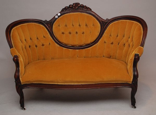 Victorian cameo back tufted settee with carved fru: Victorian cameo back tufted settee with carved fruit on crest, 39"h x 58"w