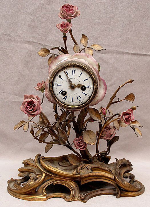 French bronze & porcelain clock "Etienne Lenoir A P: French bronze & porcelain clock "Etienne Lenoir A Paris" metal floral accents on shaped bronze base, 10 1/2"h x 5"w