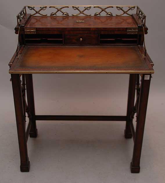 Mahogany diminutive writing desk with sword motif,: Mahogany diminutive writing desk with sword motif, lift top reveals leather surface with embossed crown, possibly Maitland Smith