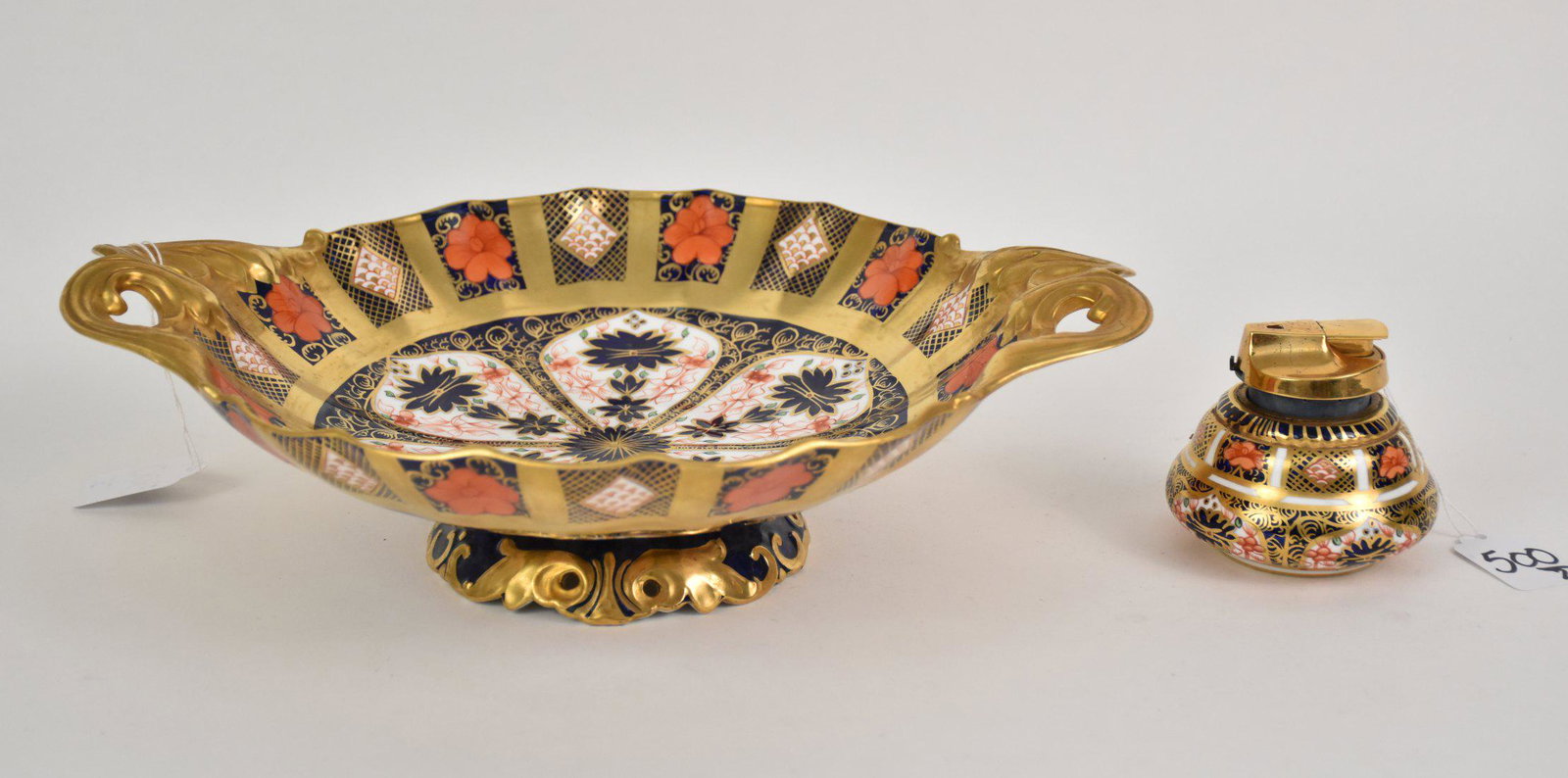 Royal Crown Derby England Imari Centerpiece Bowl &: Royal Crown Derby England Imari Centerpiece Bowl & Table Lighter - Pedestal handled bowl 3 7/8" H x 13 1/4" W x 10 1/2" dia. Lighter 3 1/8" H. Red stamped factory marks. Condition: Minor normal wear.