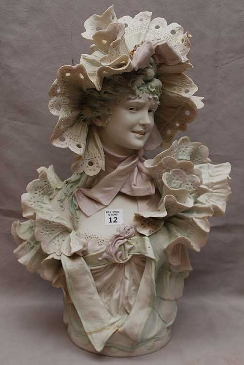 Royal Dux bisque bust , repair to bottom of dress, : Royal Dux bisque bust , repair to bottom of dress, fabulous ruffles & folds, hat has piece missing from top right and bow on top of hat has piece missing, a few chips around ruffles, 20"H x 12"L