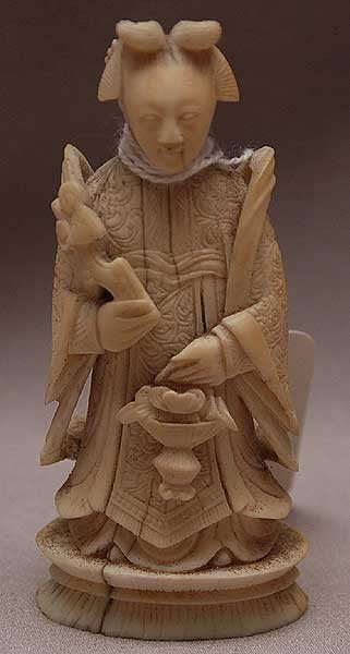 2 ivory figures, fellow with monkey on shoulder, lo: 2 ivory figures, fellow with monkey on shoulder, loose stand (toe is damaged) and female holding flower basket (age cracks at base) , 3 1/2"h and 5 1/2"h