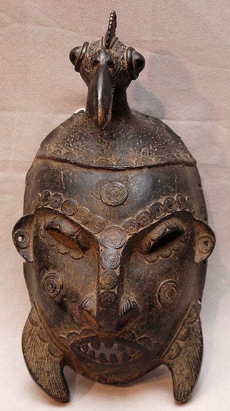 Fine African Ancestral Bronze War Mask. The well d: Fine African Ancestral Bronze War Mask. The well defined tall & elongated Calao bird's head with protruded eyes is indicative of an early mask circa 1900. Approx: 12" x 7" & bird 5.50"x 4.25"