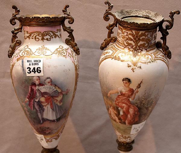 2 footed porcelain vases with ormolu mounts with c: 2 footed porcelain vases with ormolu mounts with cherub and trophy hand painted designs, signed Raguet (one vase has damage to base) 12"h