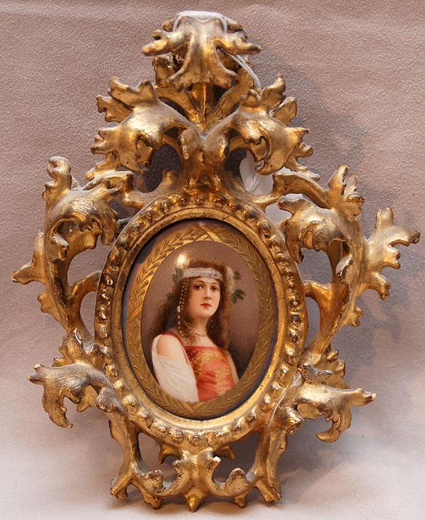 Gilded rococo carved wood frame with oval hand pai: Gilded rococo carved wood frame with oval hand painted porcelain portrait of young woman with head piece, beautifully detailed, total ht. 8"h and plaque 2 1/2"w x 3 1/2"h