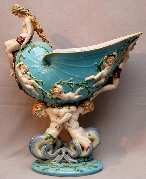 Minton Majolica nautilus shell centerpiece, suppor: Minton Majolica nautilus shell centerpiece, supported by a pair of mythological merman and scantily clad maiden with flowing hair atop the shell which is decorated with sea babies swimming amongst str