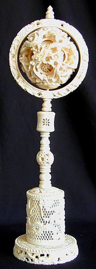 ANTIQUE CHINESE CARVED IVORY DRAGON 'MYSTERY BALL': ANTIQUE CHINESE CARVED IVORY DRAGON 'MYSTERY BALL'12"H, finely & intricately carved mystery ball w/ allover dragon design, multi carved balls inside one another, baleen dragon eyes, fine condition & p