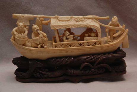 Chinese Ivory carving of a "Junk", Late 19th/early: Chinese Ivory carving of a "Junk", Late 19th/early 20th Century, Delicately carved boat with seven figures doing daily tasks, mounted on hardwood carved stand (one of the legs is missing on bottom of