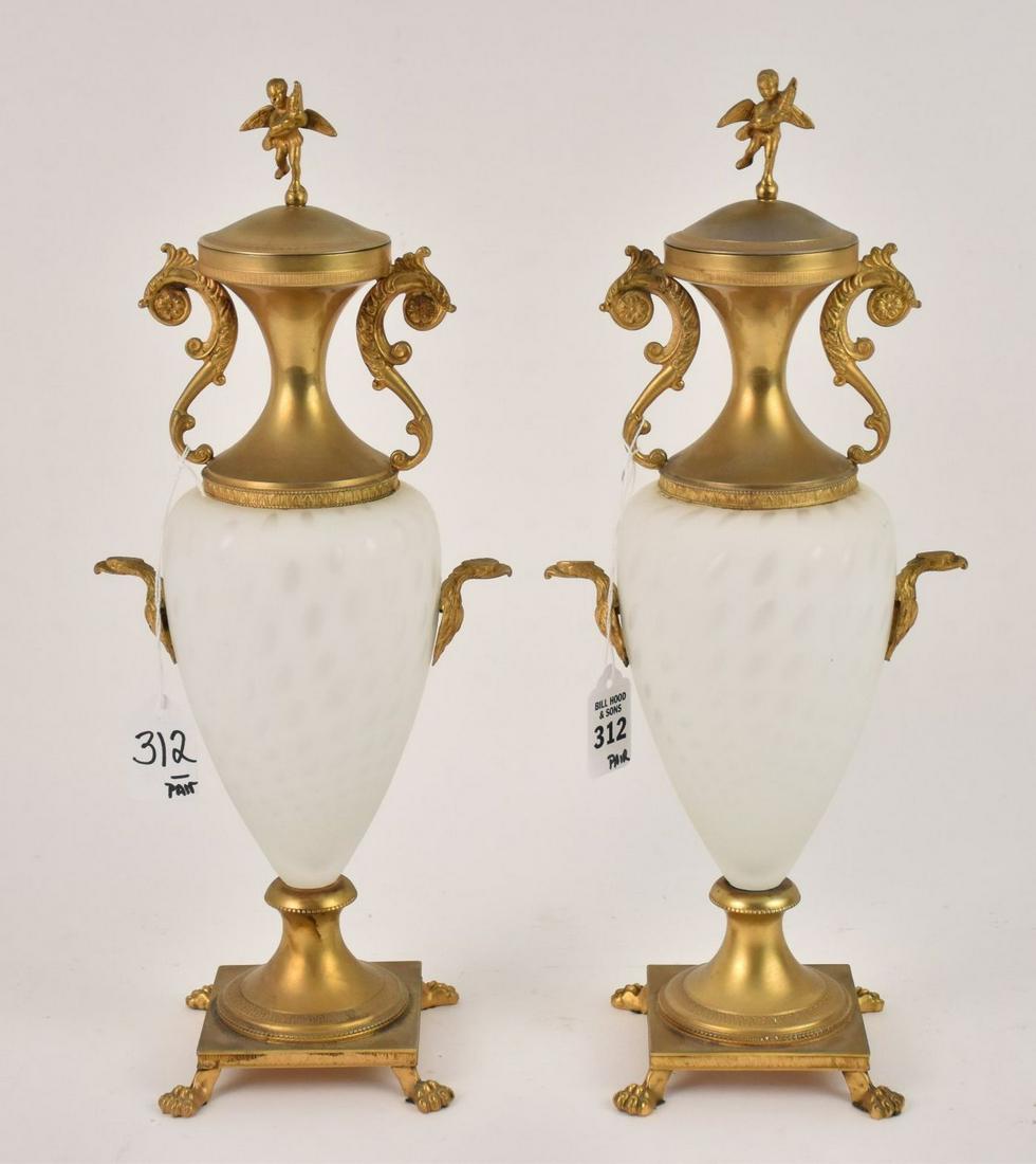 Pair Italian Gilt Metal & Frosted Glass Covered Urns -: Pair Italian Gilt Metal & Frosted Glass Covered Urns - An amphora-form covered urn in white frosted glass with gilt metal base, neck, eagle head "handles" and putti lid. 15 3/4" H. Condition: Minor no