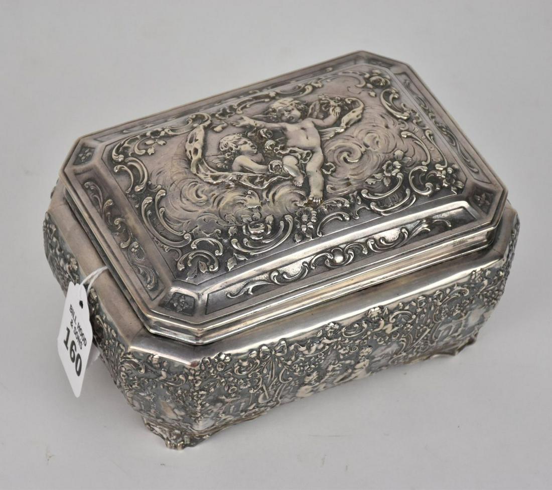 AN 800 STERLING SILVER LIDDED BOX - Continental. Marked 800. Hallmarked, of repoussé motif, putti at (1 of 6)