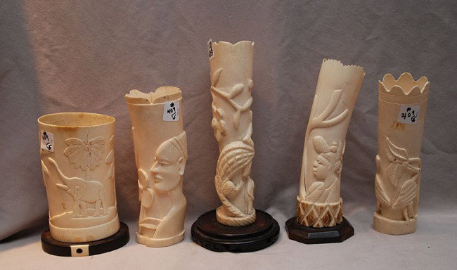 5 African carved ivory tusks, tallest is 10"h, sho: 5 African carved ivory tusks, tallest is 10"h, shortest is 9"h