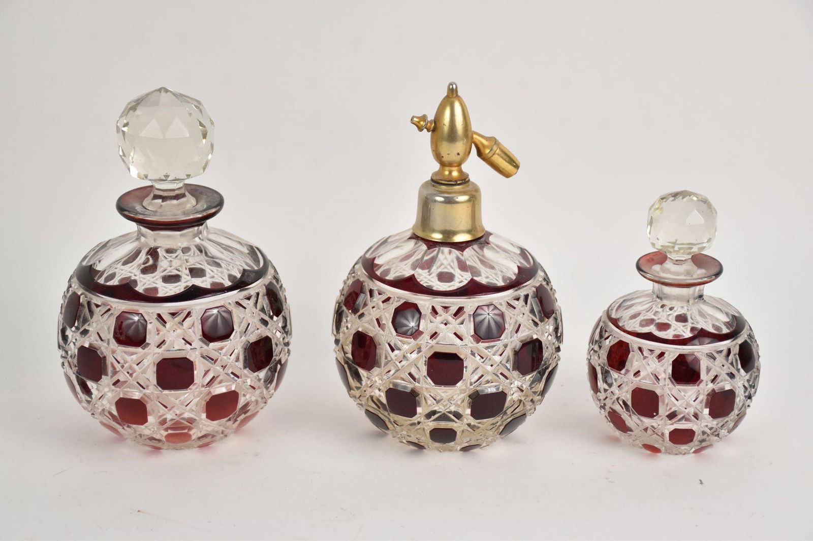 Three Ruby Cut-To-Clear Perfume Vanity Bottles - Two bottles with stoppers, one with atomizer. (1 of 4)