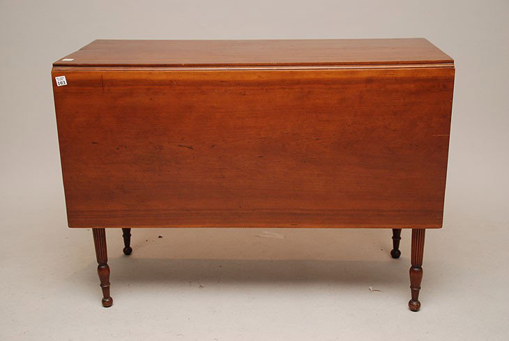 Cherry 19th century drop leaf table on round reede: Cherry 19th century drop leaf table on round reeded legs with button feet, 48"w x 30"h x 28"d