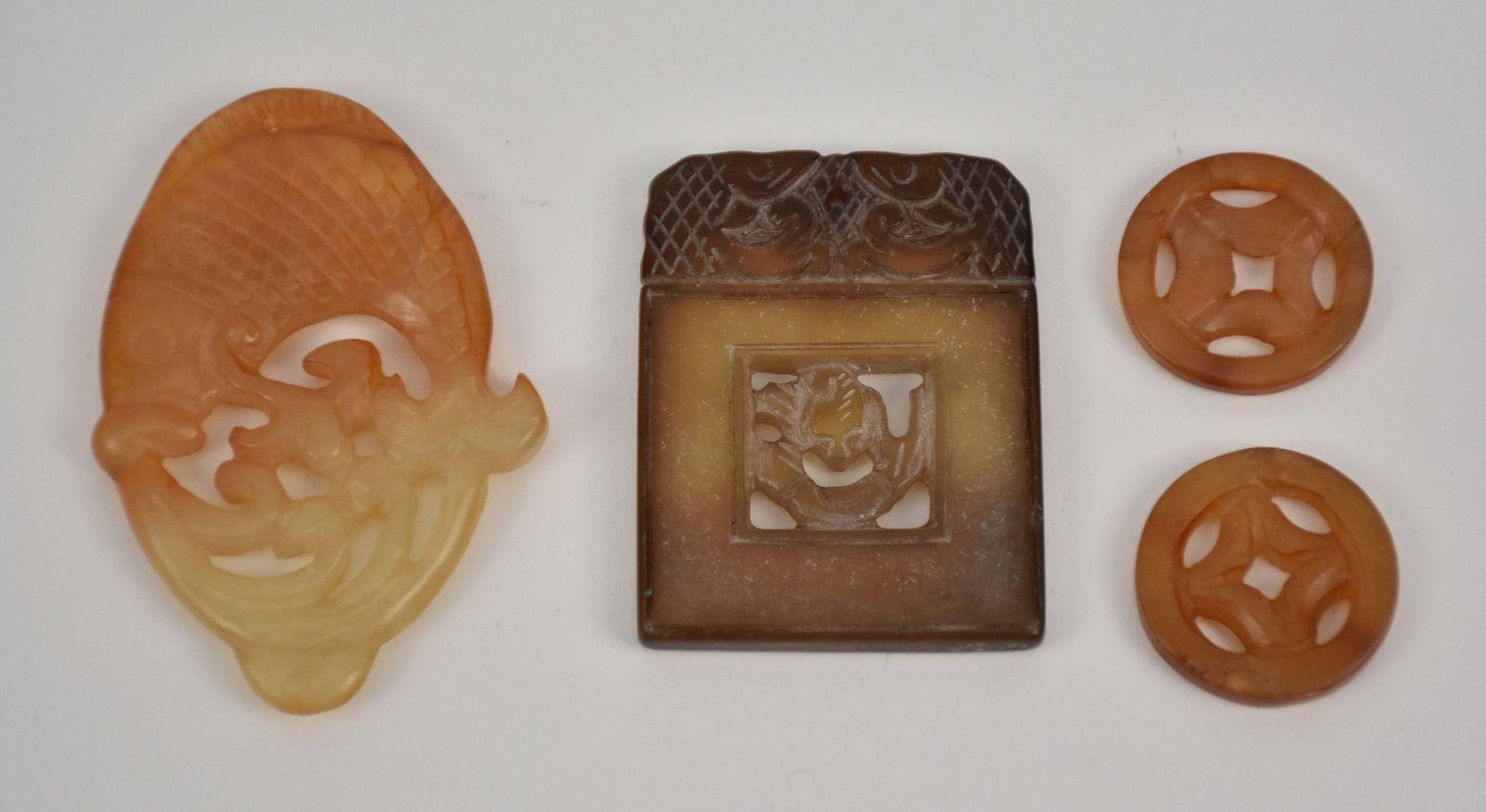 4 Chinese Jade Pieces.  2 round 1" each, 1 fish motif 2.5"  and 1 square floral motif 2" x 1.75" (1 of 6)