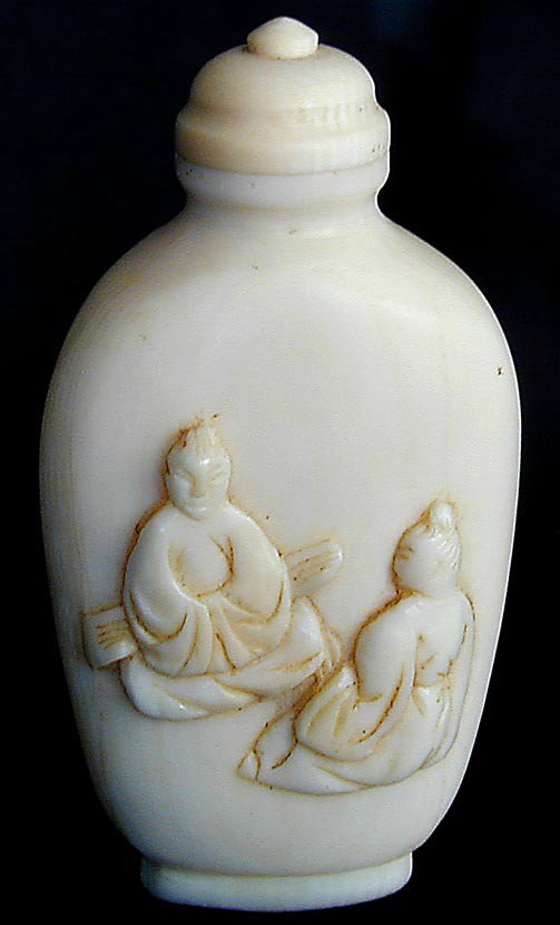 OLD CHINESE IVORY SNUFF BOTTLEAn old Chinese ivory: OLD CHINESE IVORY SNUFF BOTTLEAn old Chinese ivory snuff bottle, the front carved with 2 male figures, the reverse etched with bird on tree branch and calligraphic poem and artist seal in red, 3"H, ve