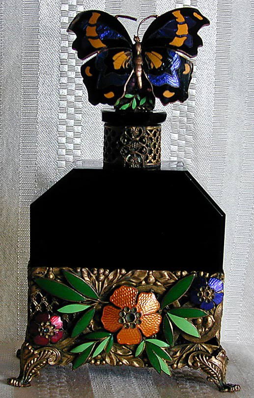 AUSTRIAN ART NOUVEAU PERFUME BOTTLEA striking blac: AUSTRIAN ART NOUVEAU PERFUME BOTTLEA striking black glass and vividly colored enameled perfume bottle with enameled butterfly stopper and enameled & gilt metal floral mounts, signed Austria to foot, s