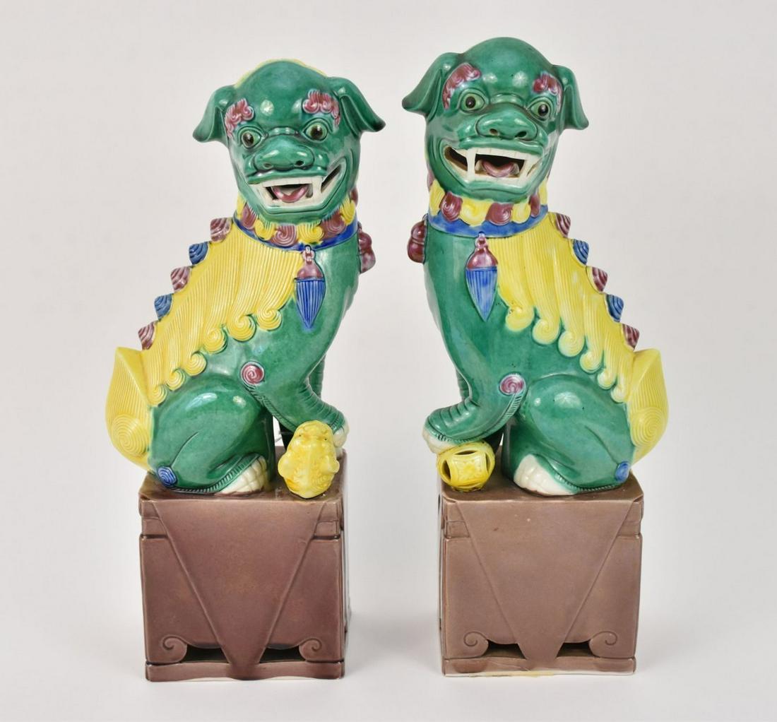 Pair Chinese Porcelain Foo Dogs - a pair of polychrome porcelain foo dogs. Decorated in green, (1 of 7)