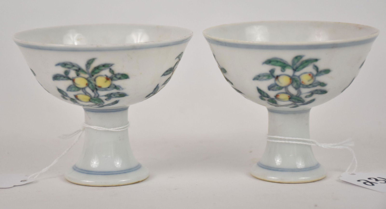 Pair Chinese Doucai Porcelain Stemmed Cups - a pair of porcelain cups with a high pedestal foot. (1 of 4)