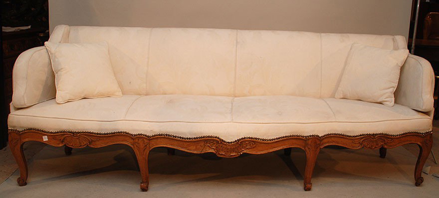 Rococo style five seat canapé, 19th c, possibly It: Rococo style five seat canapé, 19th c, possibly Italian or Scandinavian, wood frame with carved apron resting on cabriole legs and wood paneled sides, white brocade fabric, 32"h x 95"L x 23"d