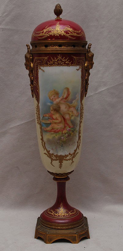 Sevres footed gilt bronze and porcelain covered ur: Sevres footed gilt bronze and porcelain covered urn with gilt metal mounts, front and reverse side cartouche of angels and instruments, signed Callot, 14 1/2"h