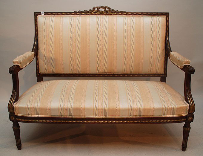 Six pc. 19th c. French suite consisting of French: Six pc. 19th c. French suite consisting of French walnut & gilded Louis XVI Fanteuils with carved acanthus leaf with rosette and bow carving at crest, 2 settees and 4 chairs