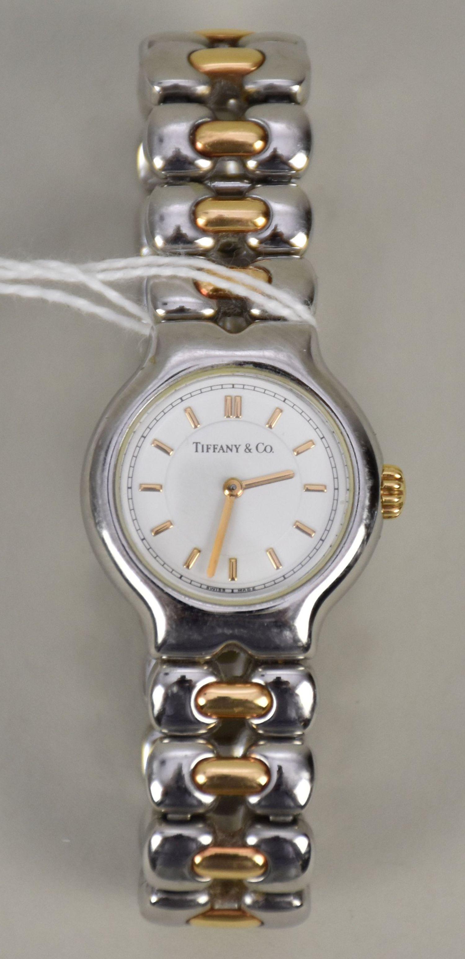Tiffany & Co. Tesoro Ladies Steel & Gold Watch L0112. Quartz. Stainless steel case with gold crown: Tiffany & Co. Tesoro Ladies Steel & Gold Watch L0112. Quartz. Stainless steel case with gold crown (25mm diameter). White dial with gold stick markers. Stainless steel bracelet with gold center links.