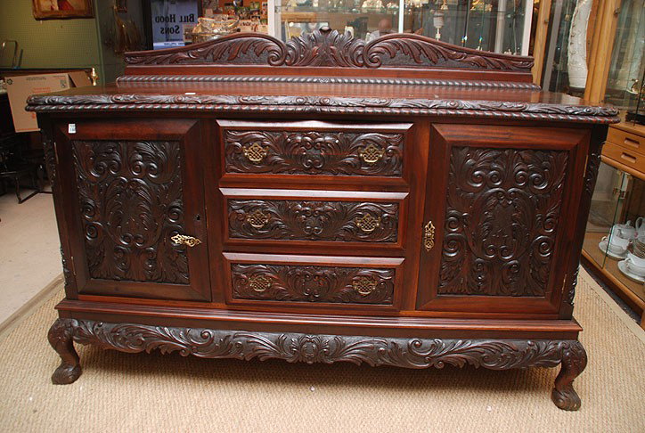 Heavily carved buffet with 2 doors flanking cente: Heavily carved buffet with 2 doors flanking center drawers and carved back splash, 39"h x 67"w