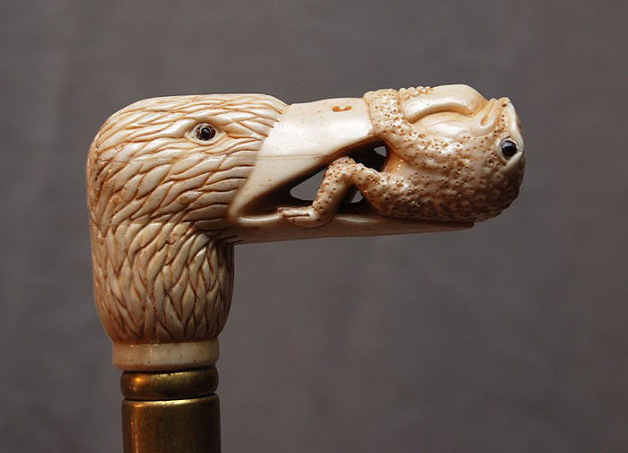 Marine ivory handled walking stick, bird with fro: Marine ivory handled walking stick, bird with frog in mouth, 37"L