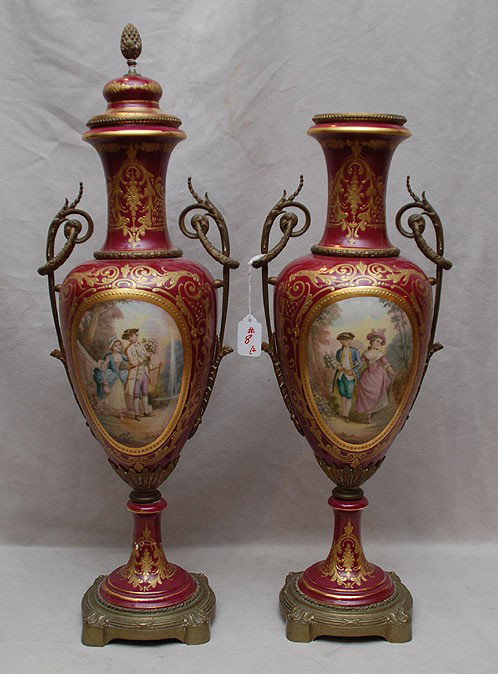 Pair of large Sevres urns, with hand painted panels : Pair of large Sevres urns, with hand painted panels front and back with gilded accents, 26"h (both bases have cracks and 1 missing its top)