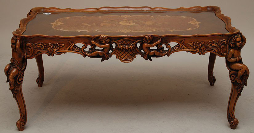 Ornately carved inlay coffee table with figural su: Ornately carved inlay coffee table with figural supports