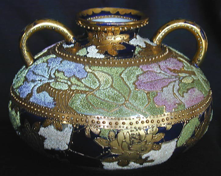 ANTIQUE NIPPON CORALENE VASE Circa 1905-1910 Japa: ANTIQUE NIPPON CORALENE VASE Circa 1905-1910 Japanese Coralene double handled vase with multi-colored floral glass beaded design measuring 4""H x 5""D and of globular form, very good condition with no