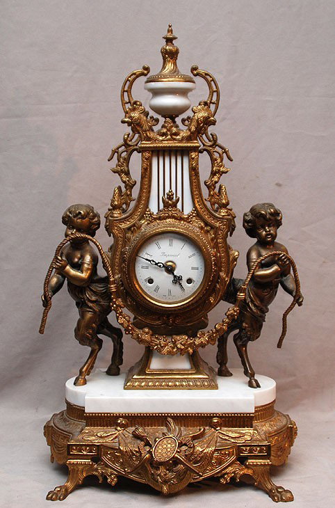 French gilt metal ornate shelf clock, 2 putti with: French gilt metal ornate shelf clock, 2 putti with garland, porcelain face, bell chime, 25"h x 14"w
