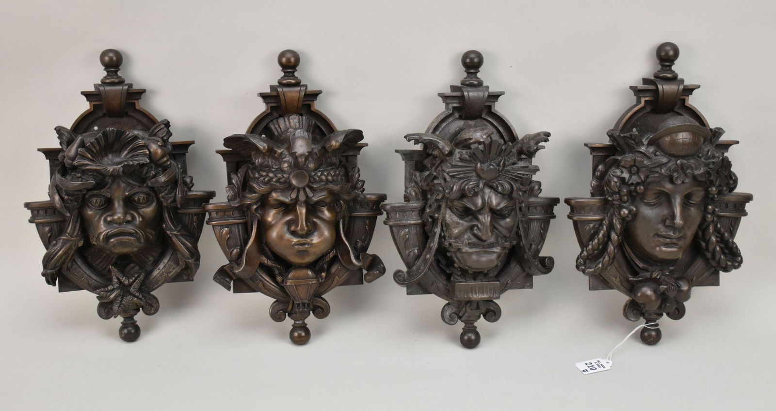 Four Antique Bronze Neoclassical Mascaron Architectural Ornaments - Four bronze wall hanging. Each: Four Antique Bronze Neoclassical Mascaron Architectural Ornaments - Four bronze wall hanging. Each depict a different deity in a neoclassical style. Group includes a water themed grotesque (Poseidon?)