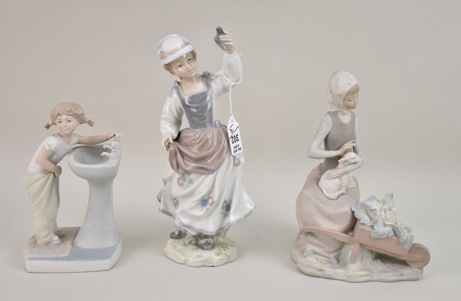 3 Lladro Figures, Girl At Sink, Girl with Lamb and Glazed Figure of Girl with Bird, 10"h tallest: 3 Lladro Figures, Girl At Sink, Girl with Lamb and Glazed Figure of Girl with Bird, 10"h tallest