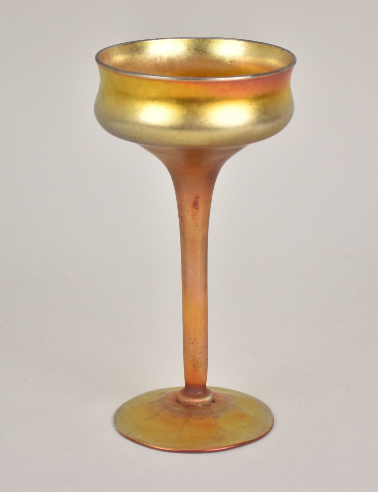 Tiffany Footed Gold Tone Cup/Stemmed Glass Deep bowl, narrow stem, and wide: Tiffany Footed Gold Tone Cup/Stemmed Glass Deep bowl, narrow stem, and wide foot. Marked: â€œLCT” H. 7” x W. 3 ½”